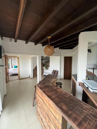 a kitchen with a wooden counter top in a room at Cabanas Alto Mar in Praia do Rosa