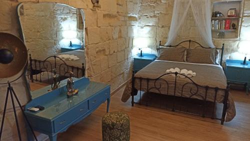 a bedroom with a bed and a mirror at Fusion Homestay Accommodation in Mosta