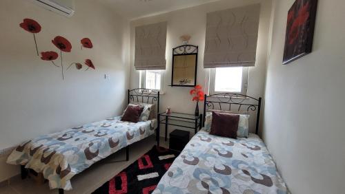 a bedroom with two beds and a window at Sea and Mountain View Beachfront Penthouse in Yalı