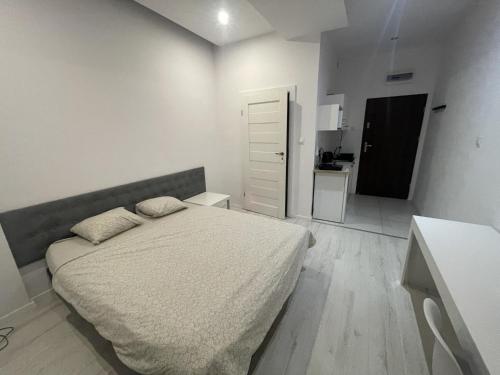 מיטה או מיטות בחדר ב-Micadas Apartamenty