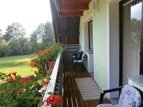 a balcony with flowers on a house at Apartment Žvan in Bohinj