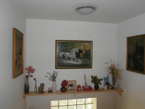 a room with a picture of a horse on the wall at Apartment Žvan in Bohinj