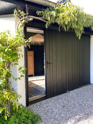 a garage with a door and a entrance at Un matin de mai in Verlincthun