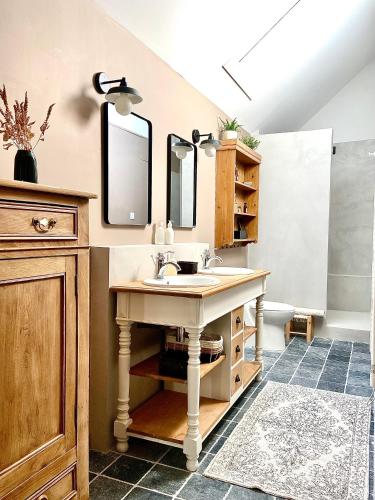 a bathroom with a sink and two mirrors at Un matin de mai in Verlincthun