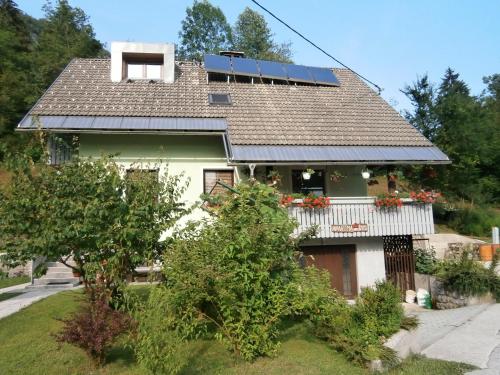 a house with solar panels on the roof at Apartment Žvan in Bohinj
