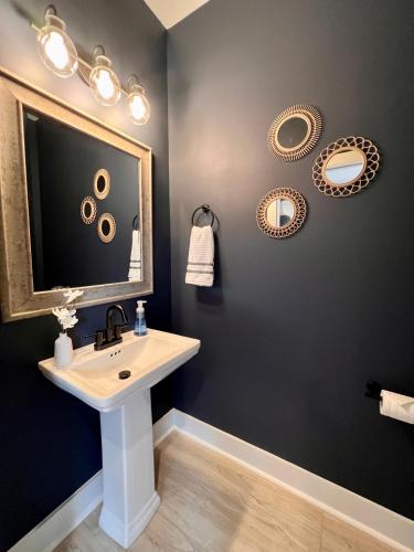 a bathroom with a sink and a mirror at Swanky Seahorse in Carolina Beach