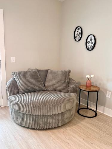 a living room with a couch and a table at Swanky Seahorse in Carolina Beach