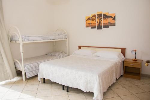a bedroom with a bed and a bunk bed at Hotel Villa Mena in Ischia