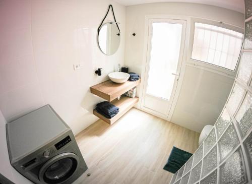 a bathroom with a sink and a washing machine at Villa Yanna in Benalmádena