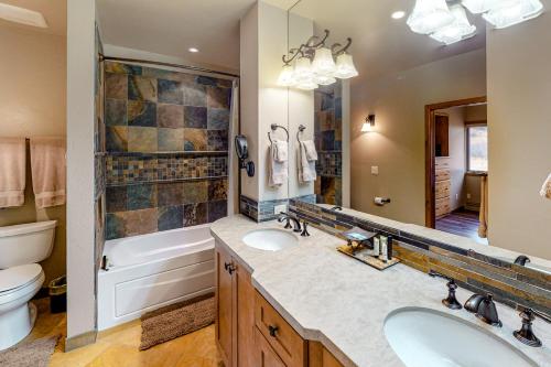 a bathroom with a tub and a sink and a toilet at Snowmass Village 19E in Snowmass Village