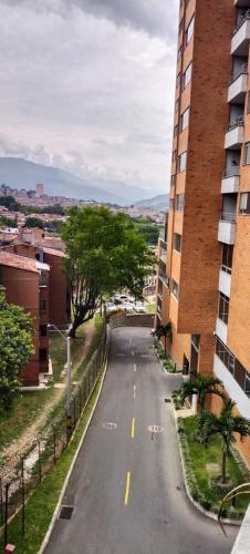 Une rue vide à côté d'un grand bâtiment dans l'établissement Cómoda habitación en apartamento, à Medellín