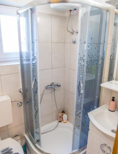 a bathroom with a shower and a toilet and a sink at Villa Celleste in Mostar