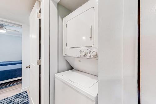 a white laundry room with a washer and dryer at Bay Creek Villa - 304 in Edisto Island