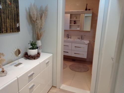 a bathroom with a white cabinet and a sink at Apartman Marija in Grude