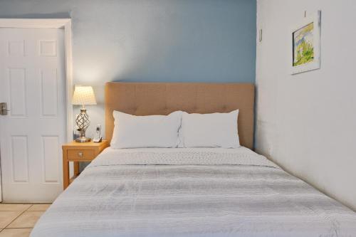 a bedroom with a large bed with a blue wall at Shortboard in Holmes Beach