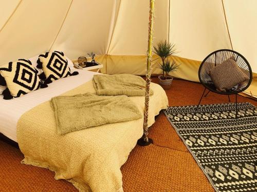a bedroom with a bed in a tent at Bluebell Wilds in Whitchurch