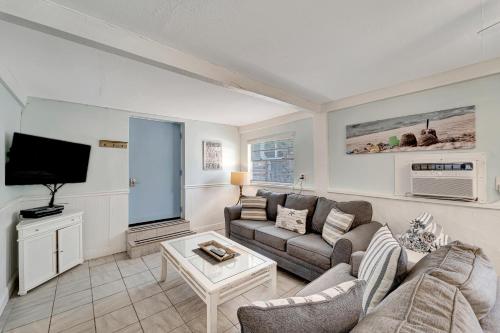 a living room with a couch and a tv at Funboard in Holmes Beach