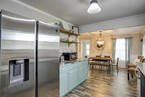 a kitchen with a stainless steel refrigerator and a table at Pura Vida - A -Murrells Inlet in Myrtle Beach