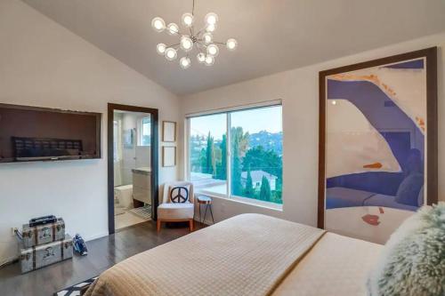 a bedroom with a large bed and a large window at Troy Hill in Los Angeles