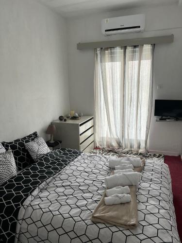 a bedroom with a large bed with pillows on it at Tasos_Studios&Apartments in Kranidi