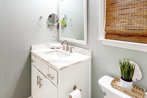 a bathroom with a white sink and a mirror at Sugar Sand Oasis in Santa Rosa Beach