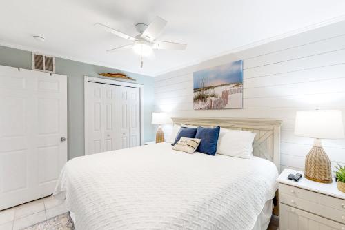 a white bedroom with a bed and a ceiling fan at Sugar Sand Oasis in Santa Rosa Beach