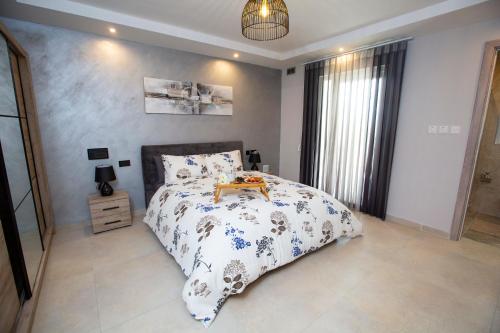 a bedroom with a bed and a table on it at Honeycomb Designer Apartment in St Paul's Bay