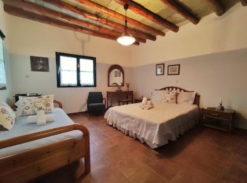 a large bedroom with two beds and a couch at Village Sense, Pergola & Unlimited View in Andros