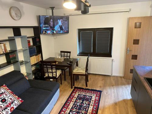 a living room with a couch and a table at Tiny Traditional House in Bucharest