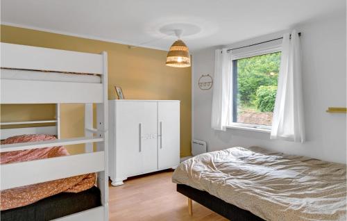 a bedroom with two bunk beds and a window at 3 Bedroom Awesome Home In Vejby in Vejby