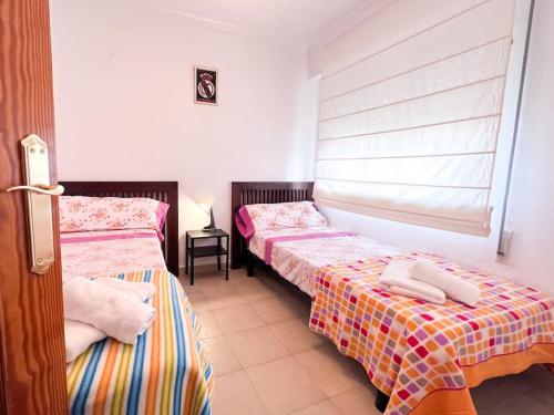 a room with two beds and a window at Apartamento en Torrevieja in Torrevieja