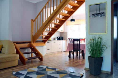 a living room with a staircase and a kitchen at U Przyjaciół in Żarnowska