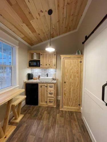 a kitchen with wooden cabinets and a counter top at Jaxsonville Southern Guesthouse in Grenada