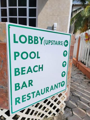 a sign for a pool beach bar restaurant at Island Magic Beach Resort in Caye Caulker