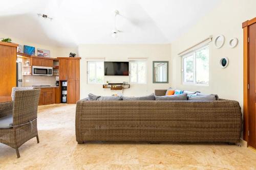 a living room with a couch and a kitchen at 2 Bed 2 Bath Villa with Jacuzzi, High Speed Wi-Fi in Sosúa