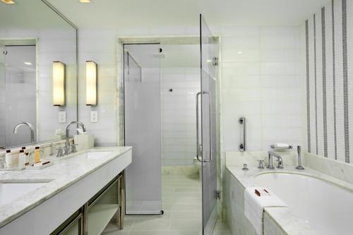 a bathroom with two sinks and a shower at Beach Club at The Boca Raton in Boca Raton