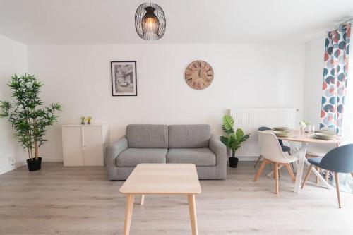 a living room with a couch and a table at Le Douillet-T2-55m2-10min Disney in Bussy-Saint-Georges