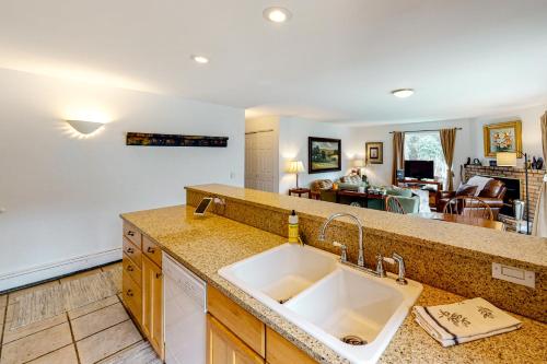 a kitchen with a sink and a living room at Snowmass Village 14A in Snowmass Village