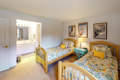 a bedroom with two beds and a mirror at Snowmass Village 14A in Snowmass Village