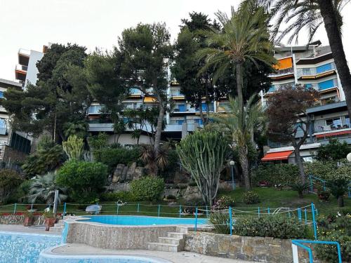 a swimming pool in front of a building at Dedelollo’s Home in Sanremo