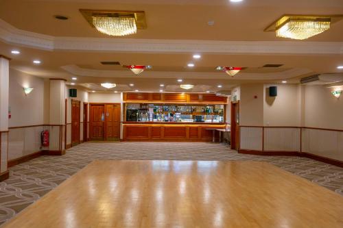 a ballroom with a dance floor and a bar at Woodlands Hotel, BW Signature Collection in Dundee