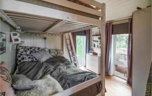 a bedroom with a bunk bed in a tiny house at Amazing Home In Mandal With Kitchen in Mandal