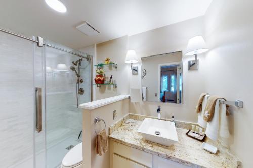 a bathroom with a sink and a shower at Peaceful Woodbridge Hideaway in Snowmass Village