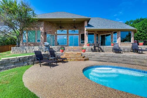 a house with a patio and a swimming pool at Lakefront Little Elm Home with Private Pool! in Little Elm