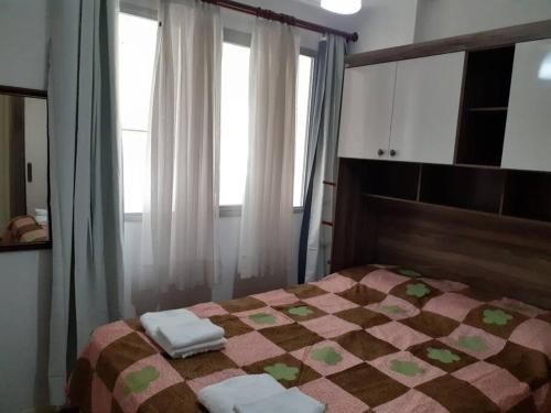 - une chambre avec un lit et 2 serviettes dans l'établissement Apartamento a 50m da praia, à Balneário Camboriú