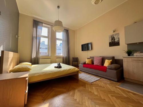 a bedroom with a bed and a couch in it at Cheerful Corner in Krakow