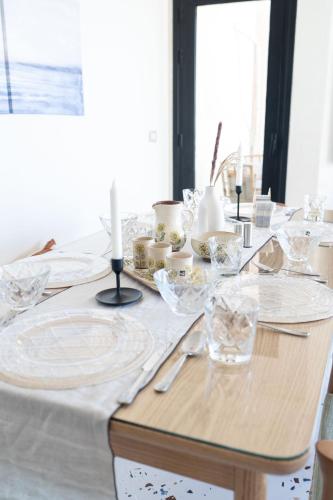 a dining table with plates and candles on it at Nabeel Homes - Seaview Building - 3 Units in Gleem in Alexandria