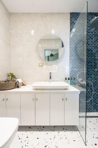 a white bathroom with a sink and a mirror at Nabeel Homes - Seaview Building - 3 Units in Gleem in Alexandria