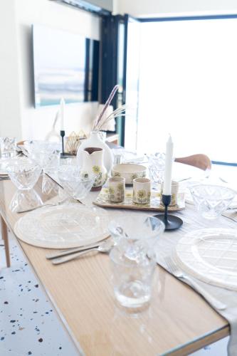 a table with white plates and candles on it at Nabeel Homes - Seaview Building - 3 Units in Gleem in Alexandria