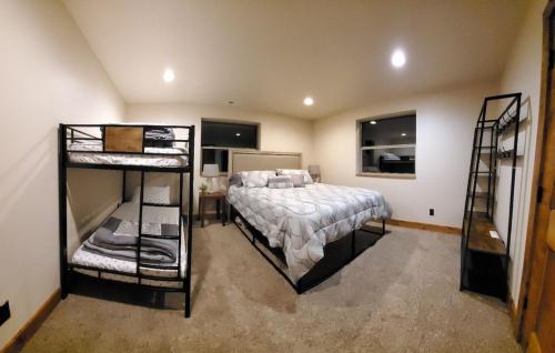 a bedroom with a bed and two bunk beds at The Mine at Bear Lake in Garden City